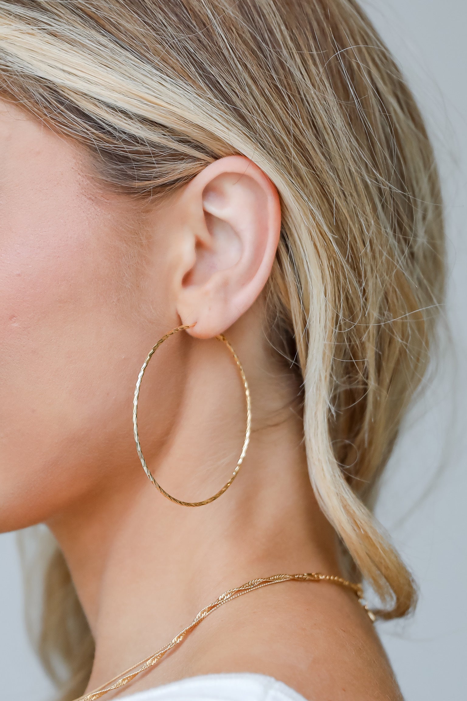 model wearing gold hoop earrings