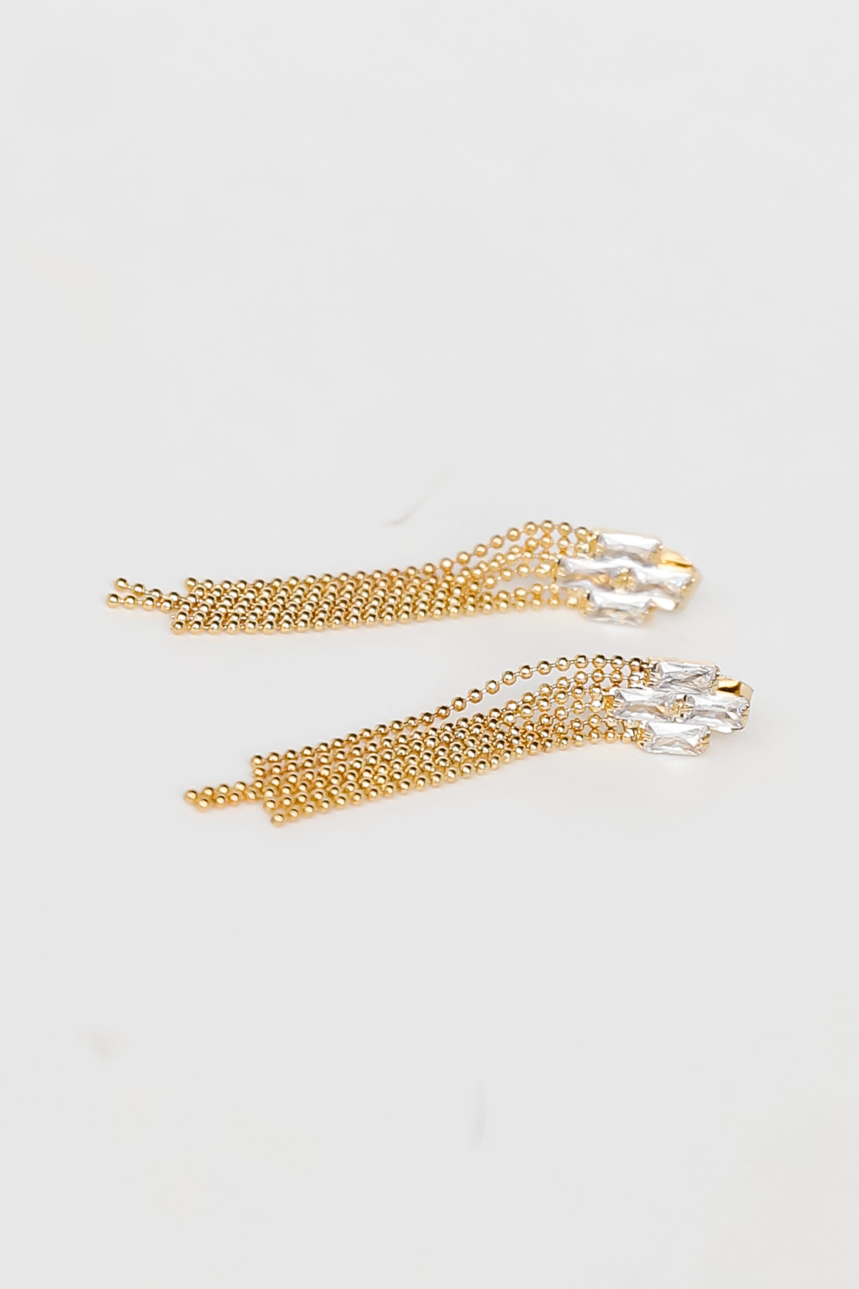 Gold Rhinestone Beaded Fringe Earrings flat lay