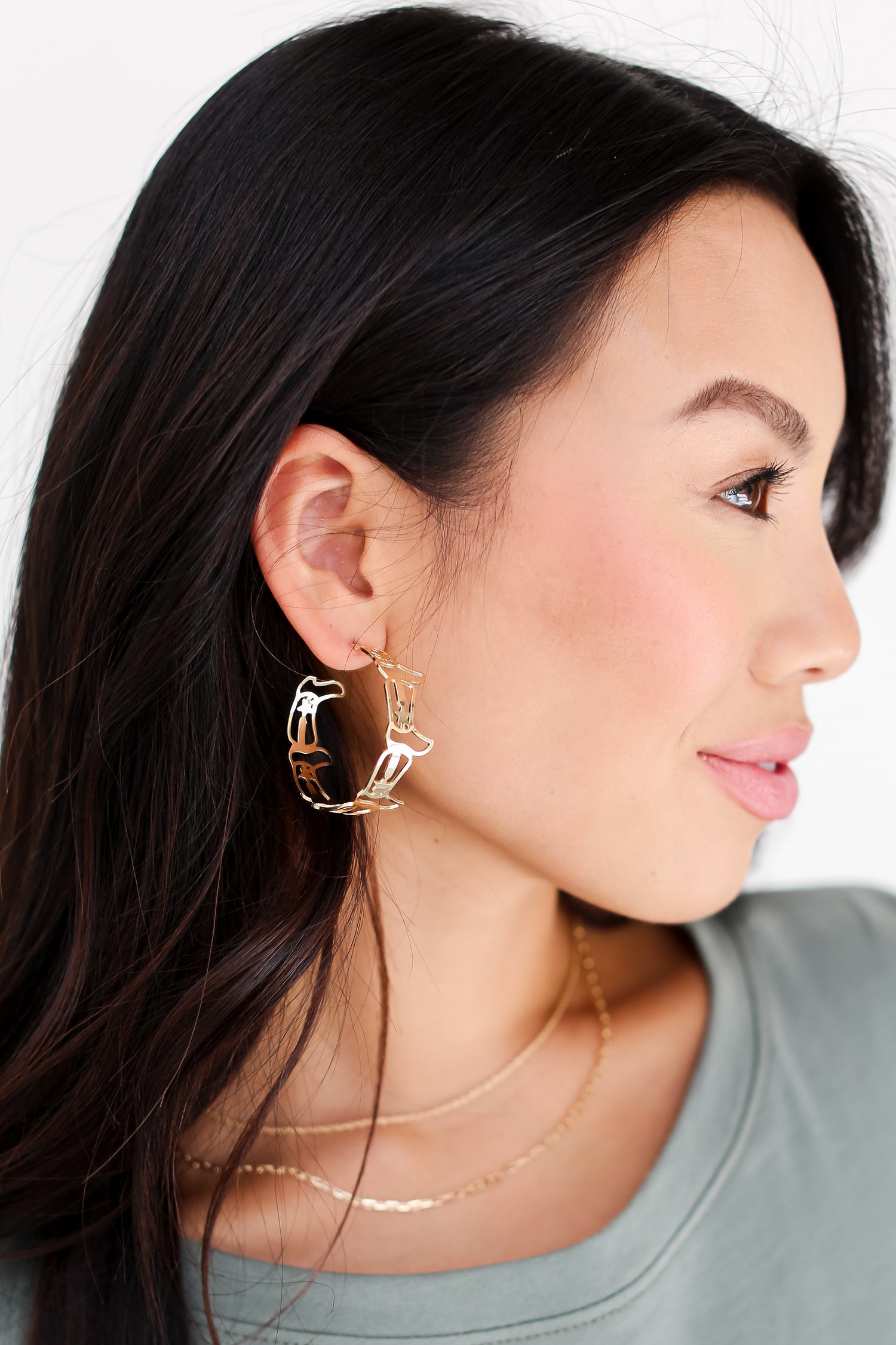 model wearing Gold Cowboy Boot Hoop Earrings