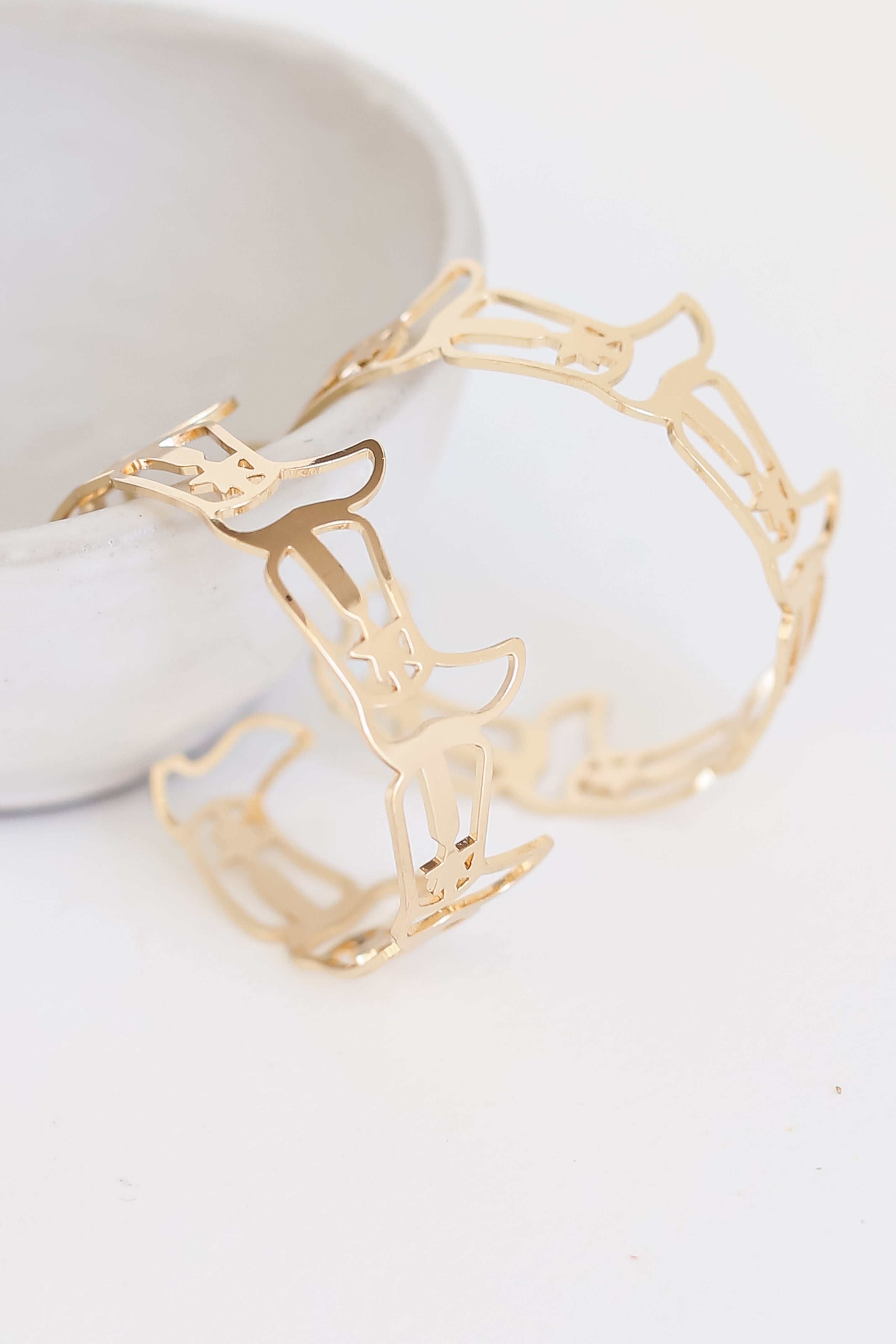 Gold Cowboy Boot Hoop Earrings flat lay