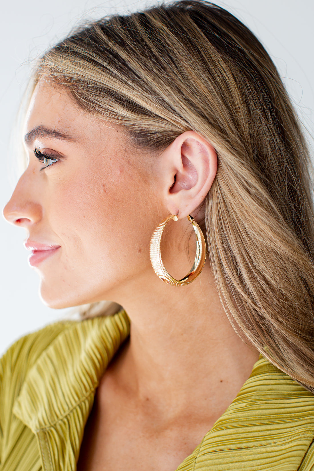 Gold Textured Hoop Earrings on model