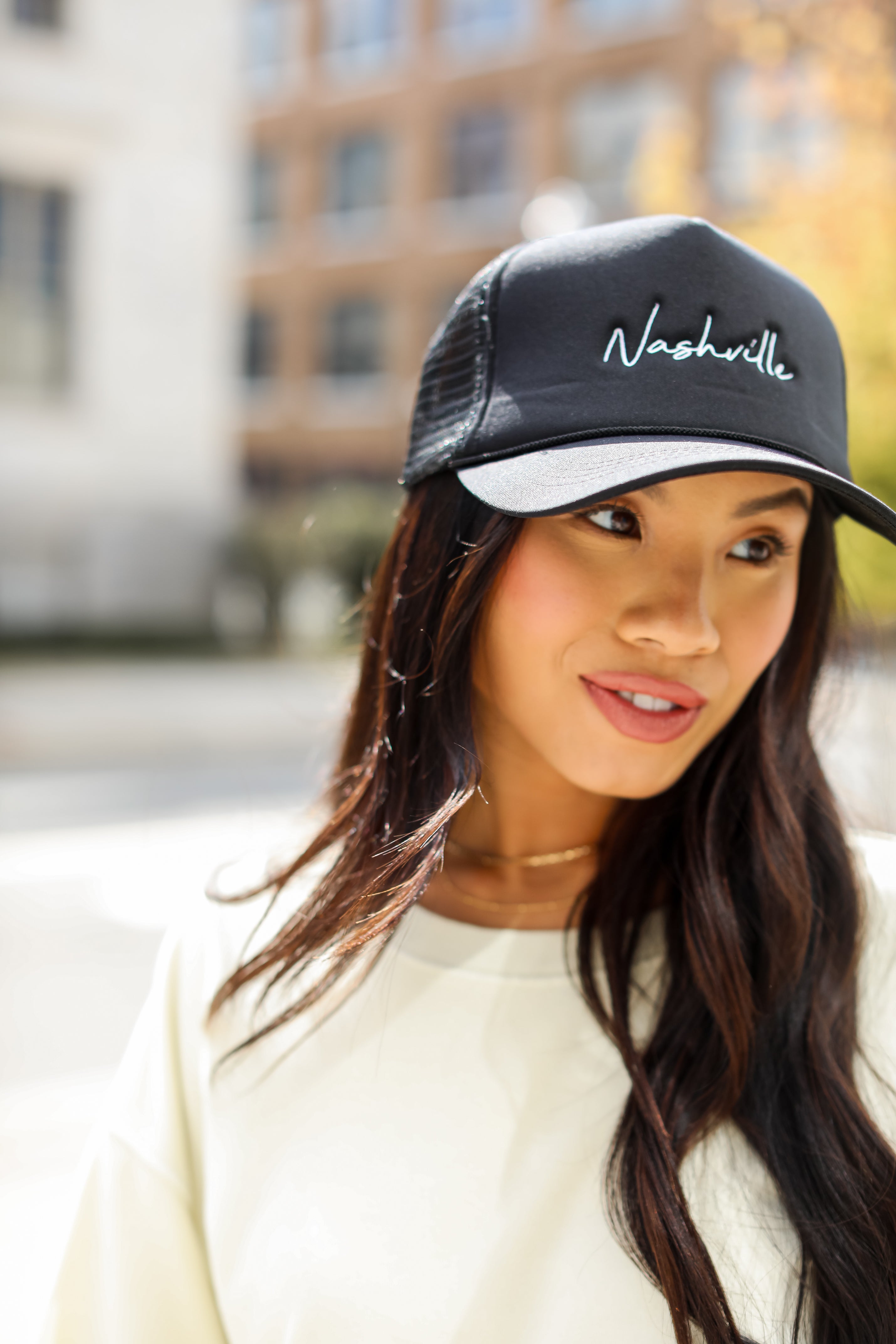 black Nashville Trucker Hat on model