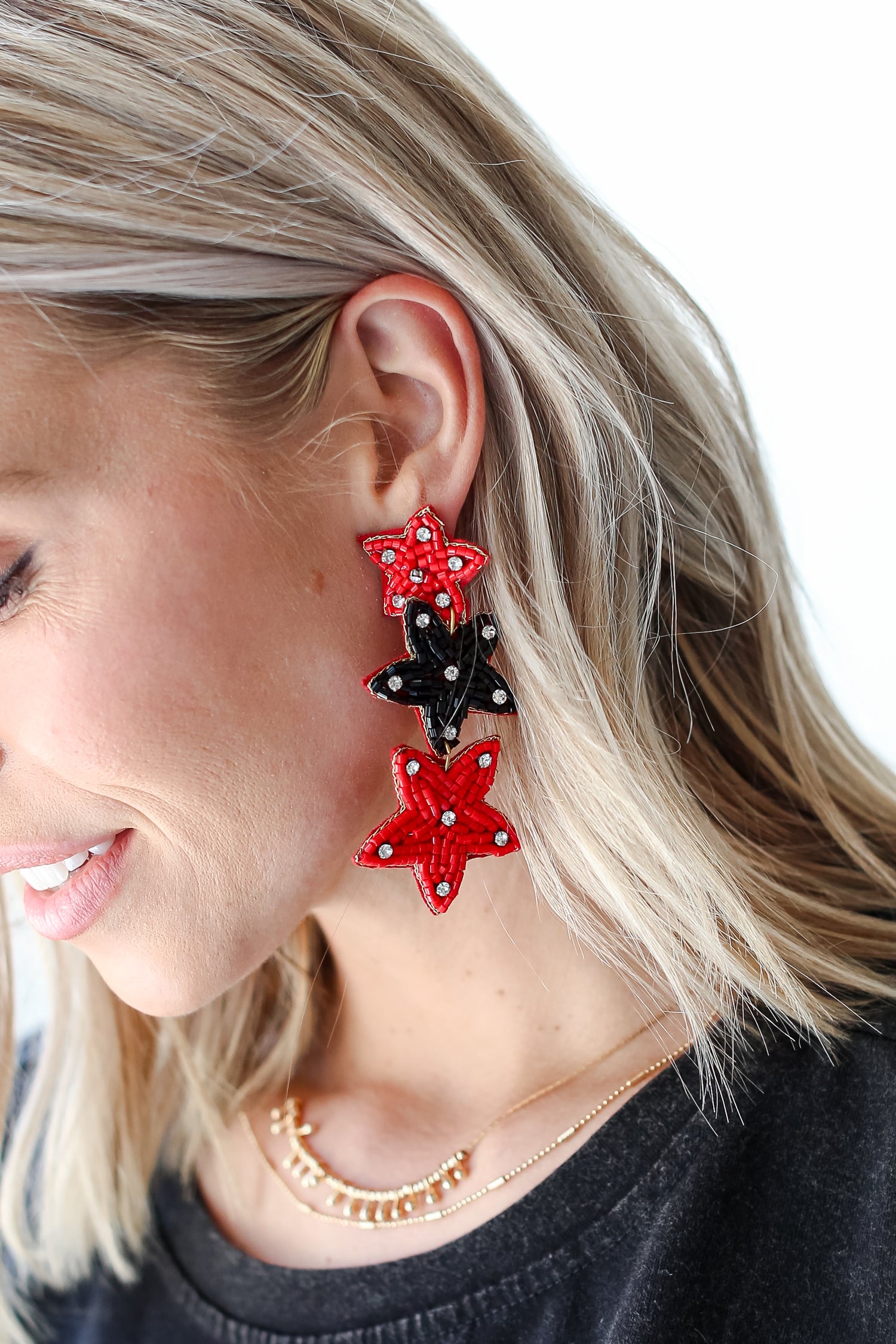 Red + Black Beaded Star Drop Earrings on dress up model