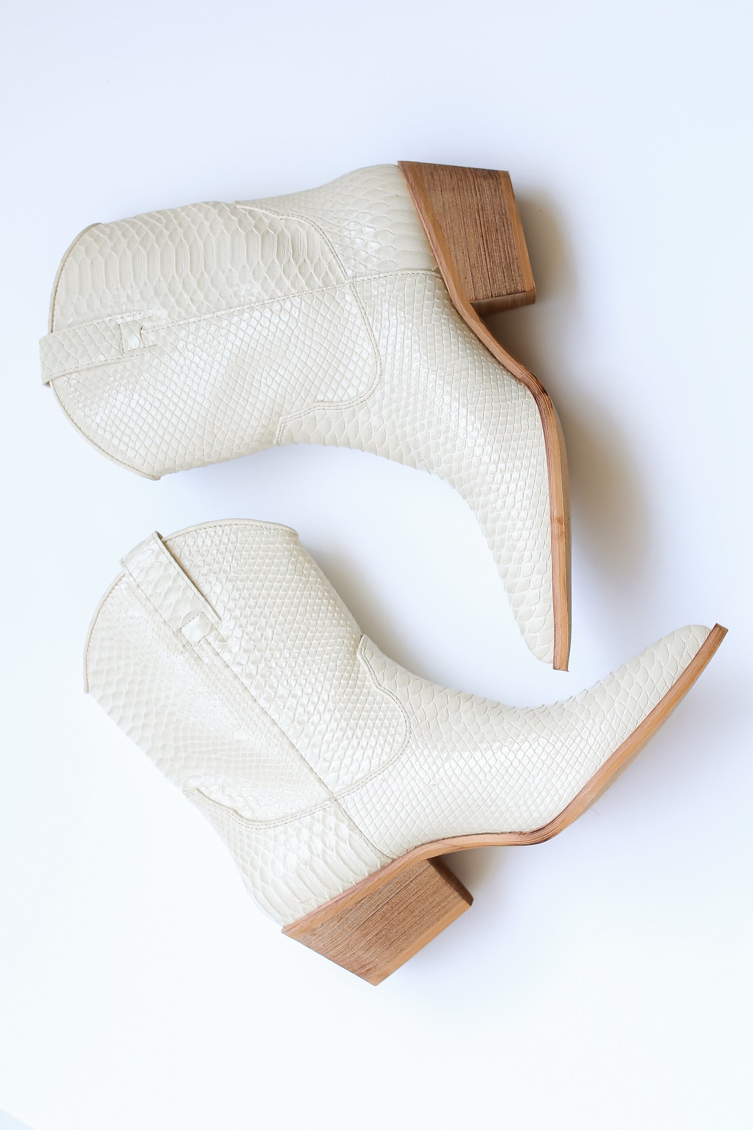 ivory snakeskin Western Booties flat lay