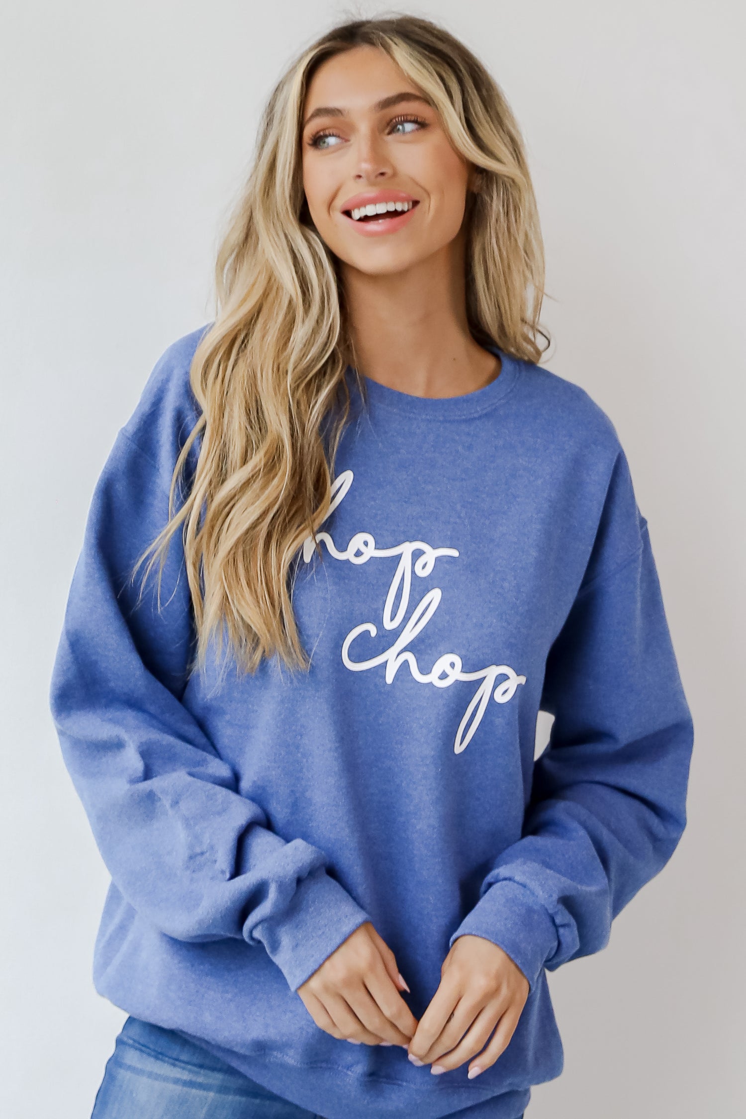 This comfy sweatshirt is designed with a soft and stretchy knit with a fleece interior. It features a crew neckline, long sleeves, a relaxed fit, and the words &quot;Chop Chop&quot; on the front. 