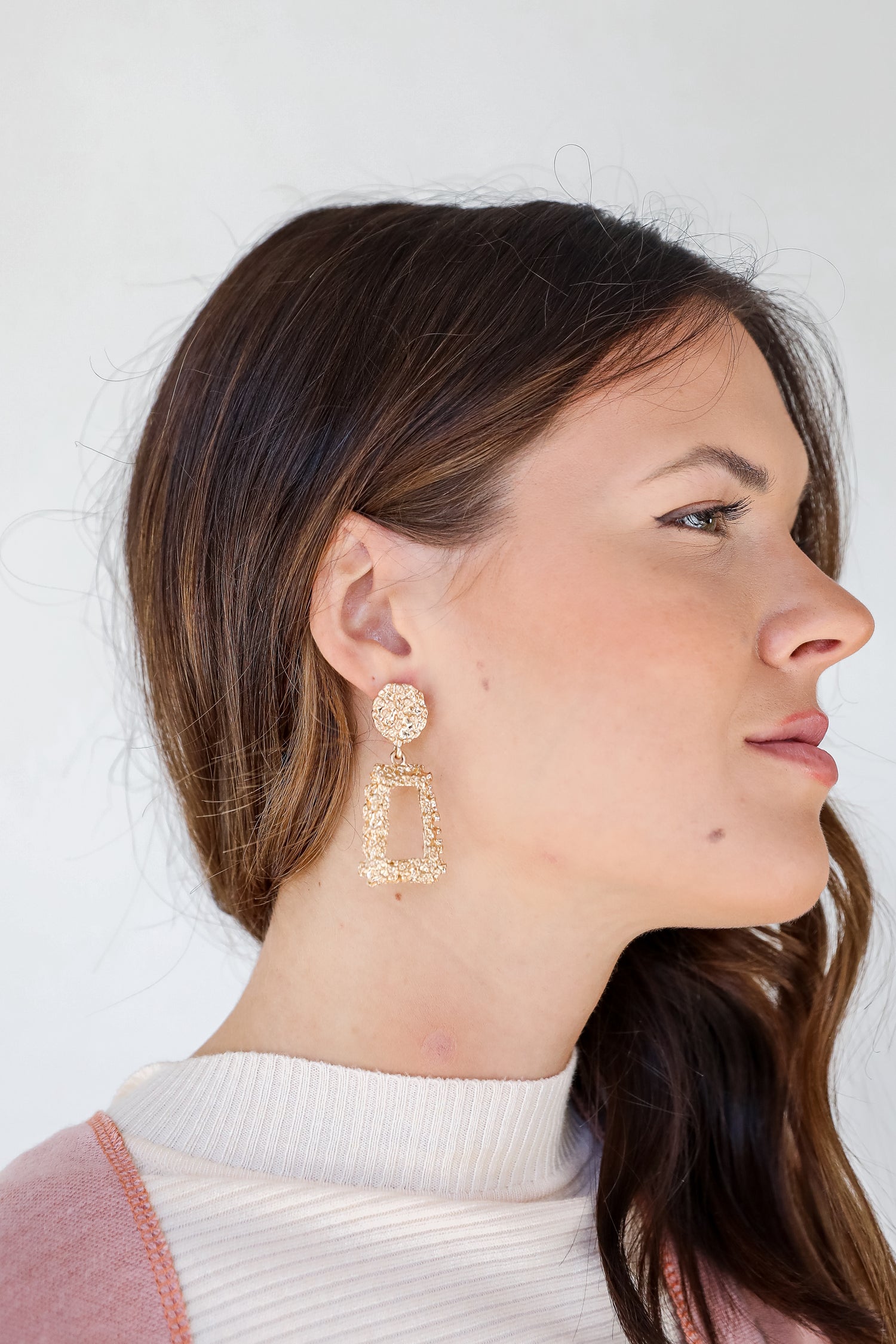 Gold Textured Drop Earrings on model